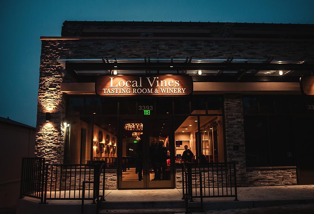 Local Vines, the cooperative tasting room and winery on Mount Diablo Boulevard in downtown Lafayette, lit at dusk.